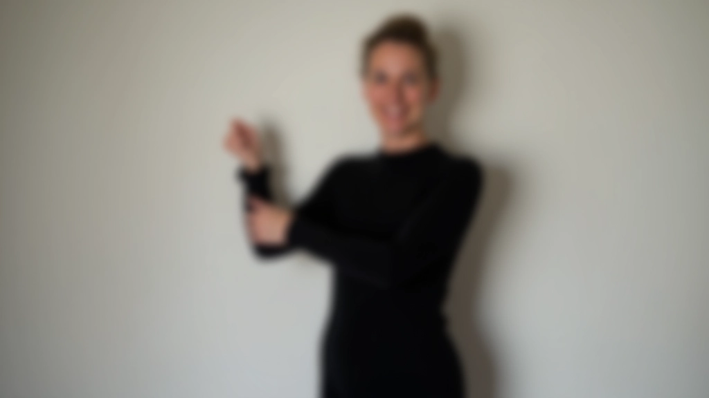 Instructor showing proper upright posture and frame position for salsa dancing to a group of mature students